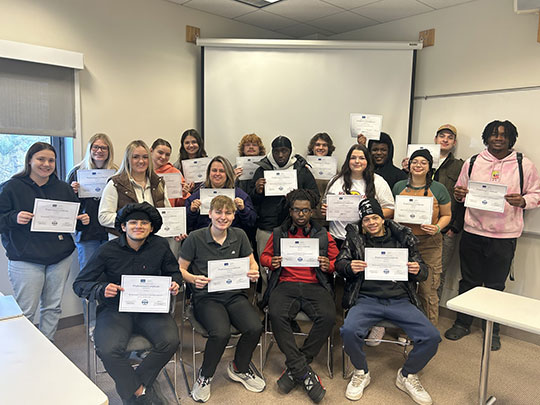 group of people holding certificates